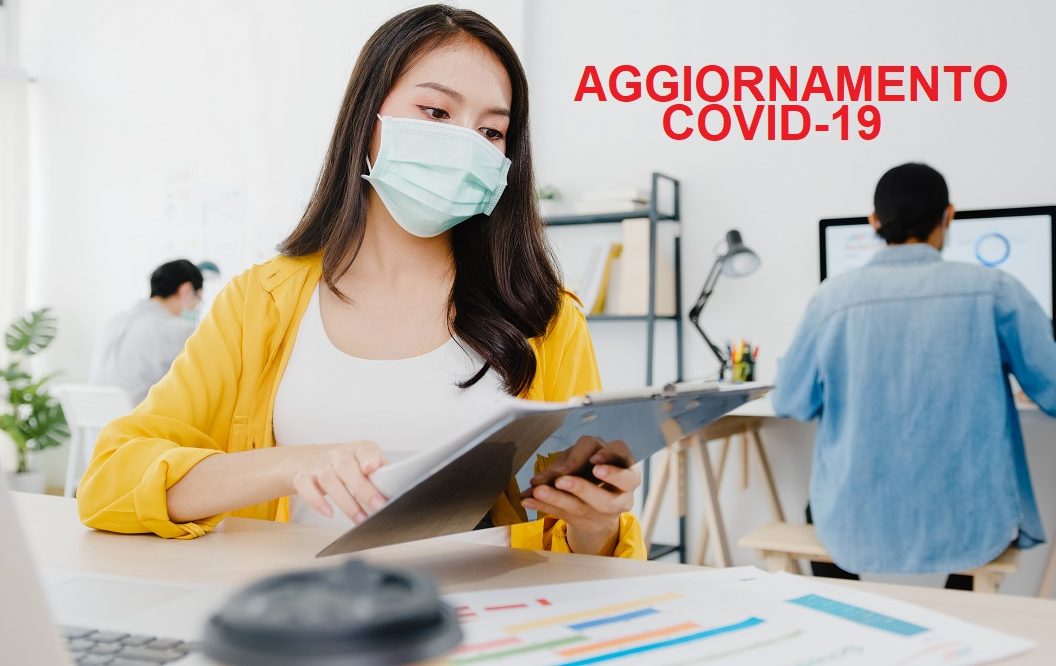 Asia businesswoman entrepreneur wearing medical face mask for social distancing in new normal situation for virus prevention while using laptop back at work in office. Lifestyle after corona virus.